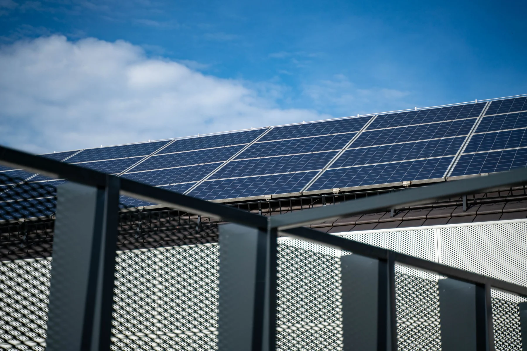 Solar array seen from below against a clear sky