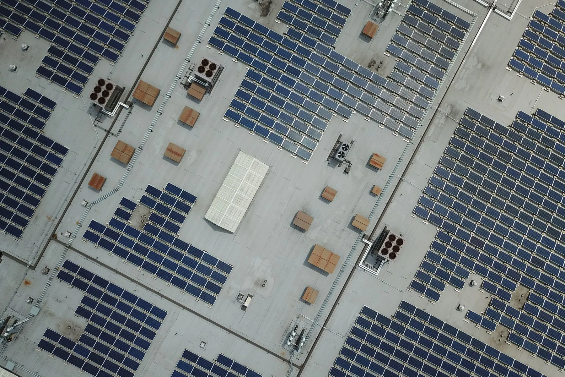Large solar array across an industrial rooftop, seen from above