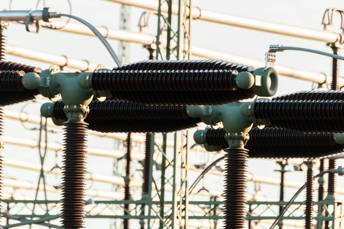Close-up of high-voltage insulators and disconnect switches